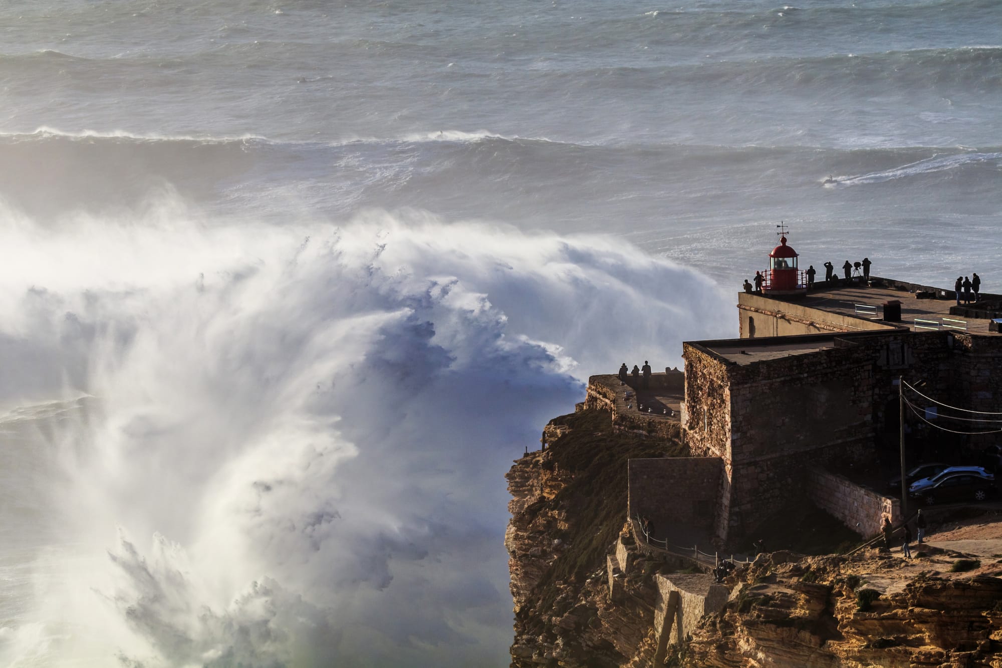 The Nazaré lighthouse above a giant Atlantic wave